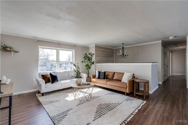 living area with a chandelier, baseboards, dark wood finished floors, and ornamental molding