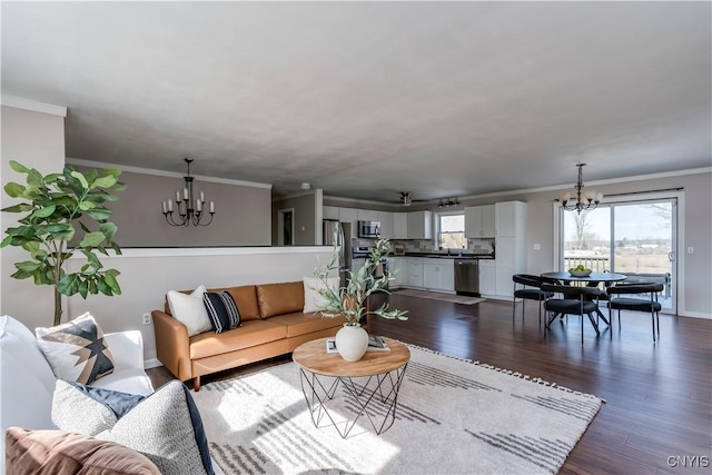 living room with baseboards, dark wood-type flooring, an inviting chandelier, and crown molding