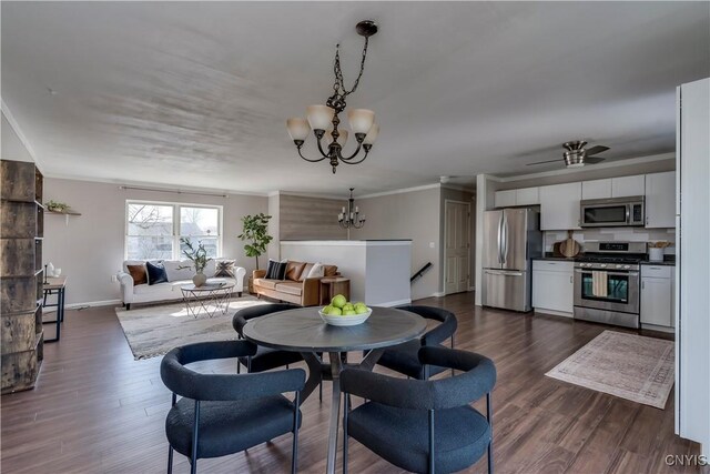 dining area with a chandelier, dark wood finished floors, crown molding, and baseboards