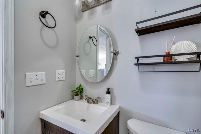 bathroom with toilet and vanity