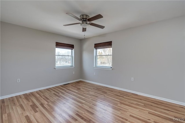 unfurnished room with light wood-style floors, baseboards, and ceiling fan