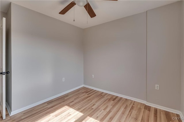 unfurnished room featuring ceiling fan, light wood-type flooring, and baseboards