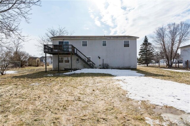 back of property with a wooden deck and stairs