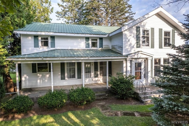 view of front of property featuring covered porch and metal roof