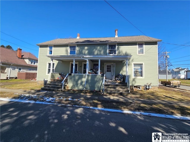 view of front of house featuring a porch and a chimney