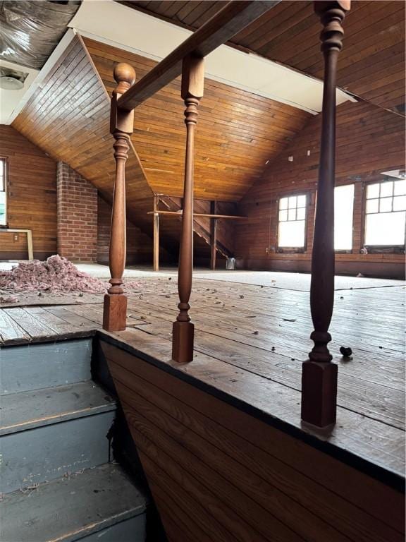 interior space with lofted ceiling, wooden walls, and wood ceiling