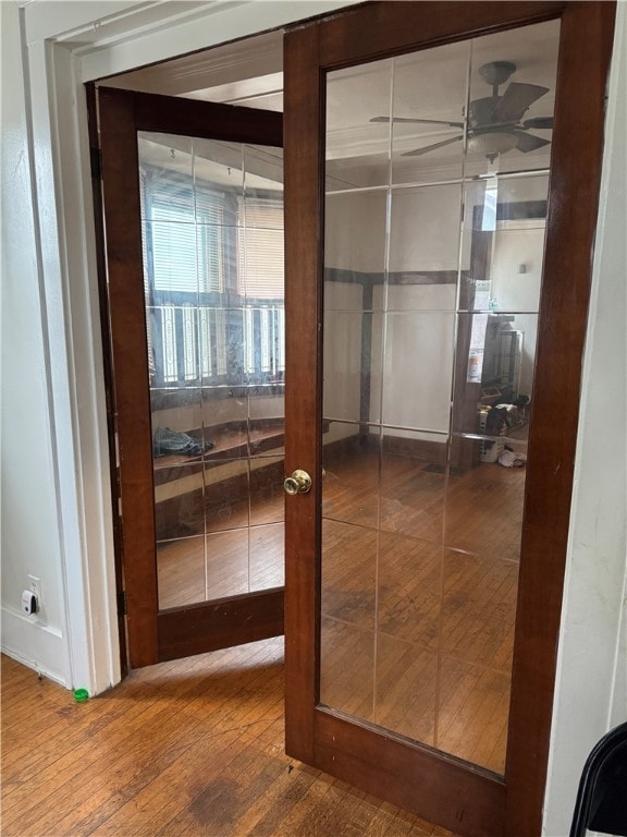 corridor featuring french doors and hardwood / wood-style flooring