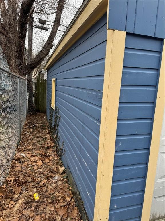 view of side of home with fence