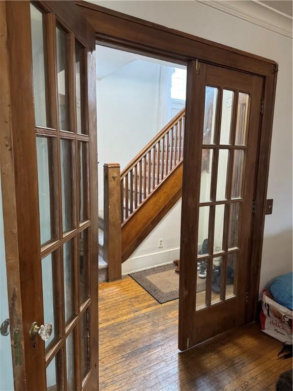 entryway featuring french doors, stairs, and hardwood / wood-style floors