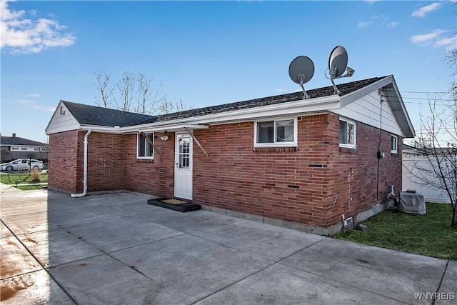 rear view of property featuring brick siding