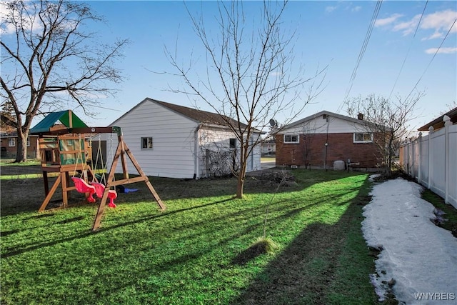 view of yard featuring a playground and fence