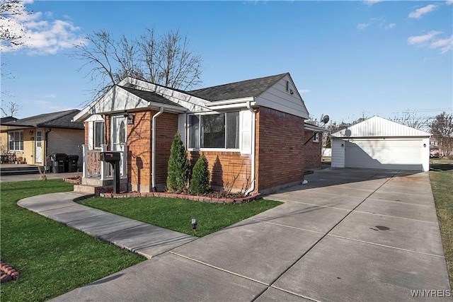 view of side of property with a yard, a detached garage, brick siding, and an outdoor structure