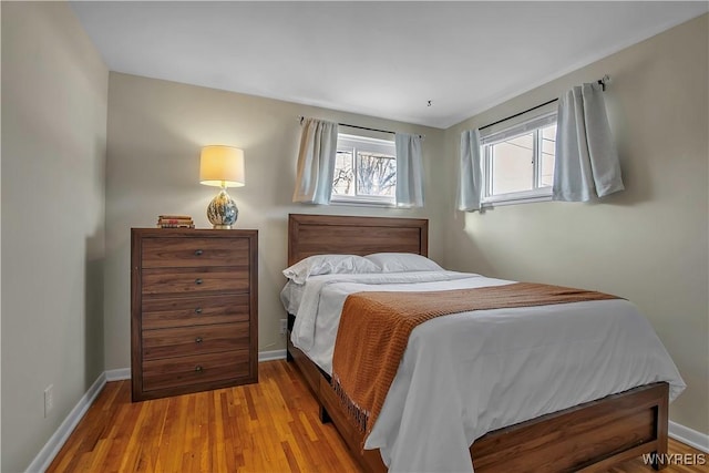 bedroom with wood finished floors and baseboards