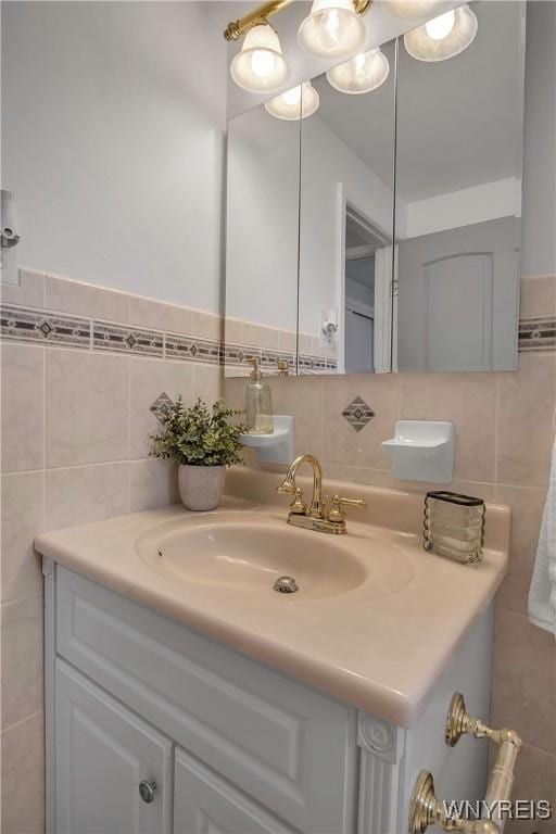 bathroom featuring vanity and tile walls