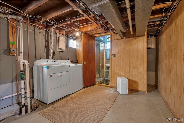 below grade area with washer and clothes dryer and wooden walls