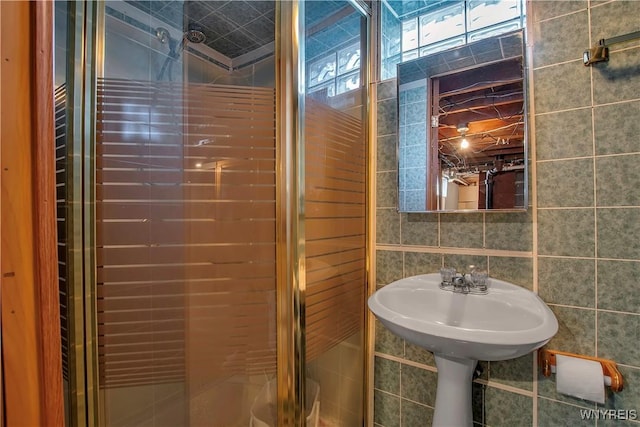 full bath featuring tile walls and a stall shower