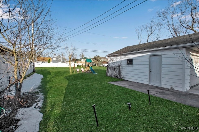 view of yard with a playground and fence