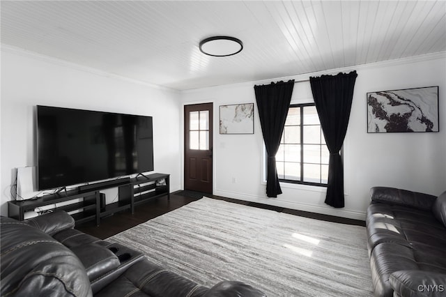 living room featuring baseboards, ornamental molding, and dark wood-style flooring