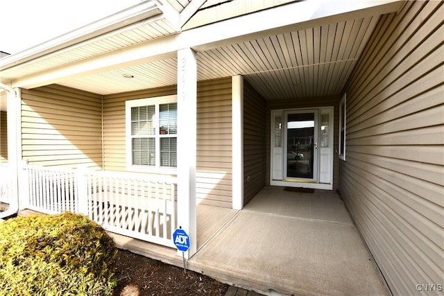 view of exterior entry featuring a porch