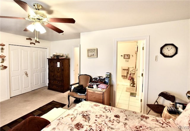 carpeted bedroom featuring a closet and ceiling fan