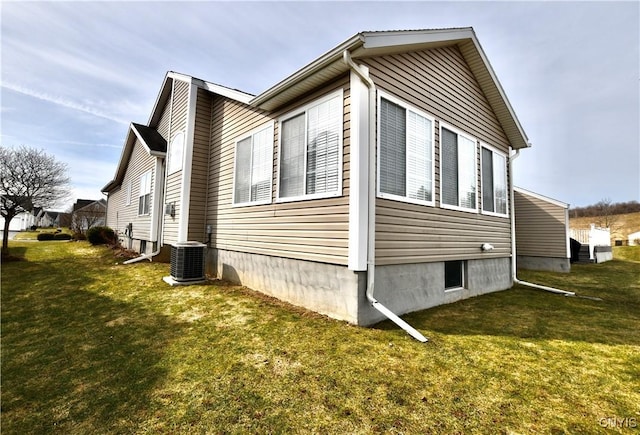 view of property exterior featuring a yard and central AC unit