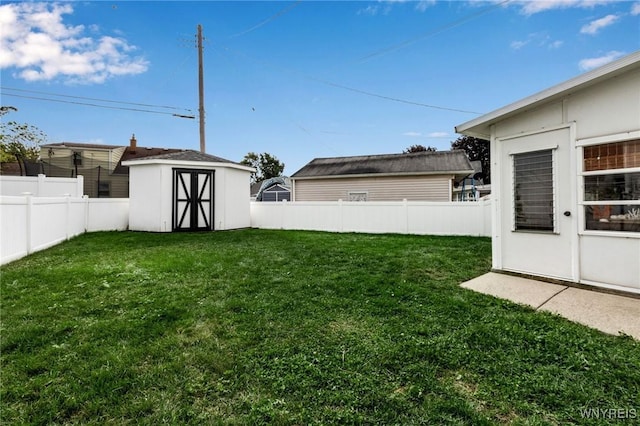 view of yard with a fenced backyard, an outdoor structure, and a shed