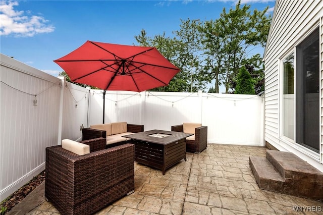 view of patio featuring an outdoor living space with a fire pit and a fenced backyard