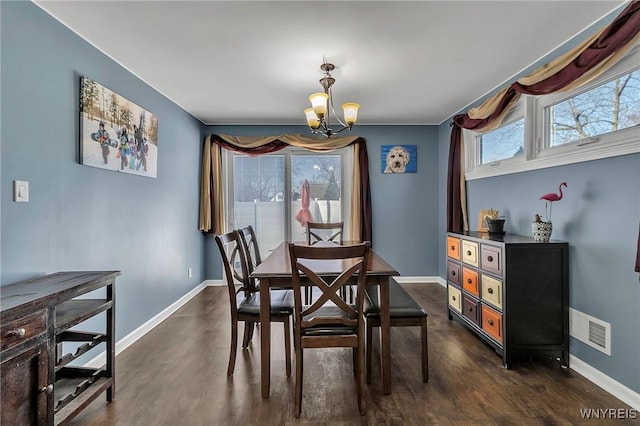 dining space with a notable chandelier, visible vents, baseboards, and dark wood-style flooring