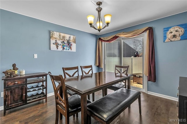 dining room with baseboards, wood finished floors, and a chandelier