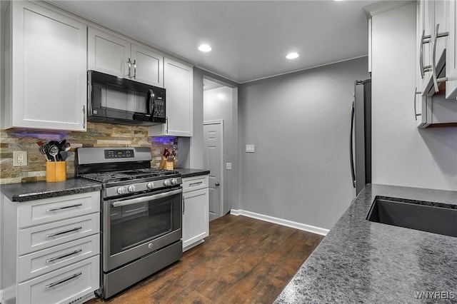 kitchen with recessed lighting, dark wood-style flooring, white cabinets, appliances with stainless steel finishes, and tasteful backsplash