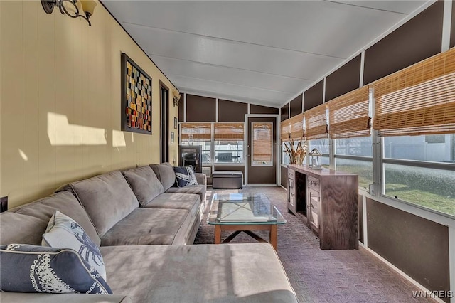 sunroom featuring vaulted ceiling and a healthy amount of sunlight