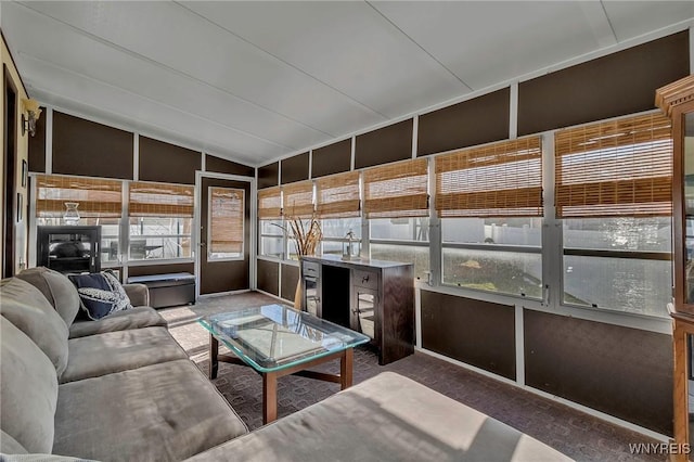 unfurnished sunroom with vaulted ceiling