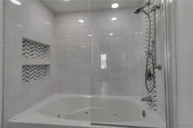 bathroom with a combined bath / shower with jetted tub