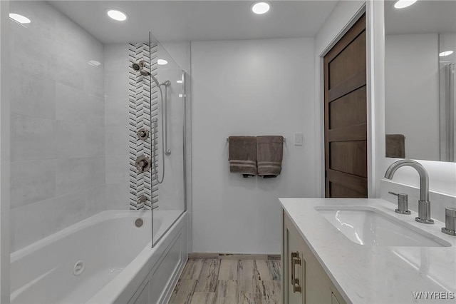 full bath featuring recessed lighting, shower / bathing tub combination, wood finished floors, and vanity