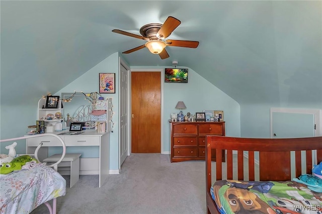 carpeted bedroom with baseboards, lofted ceiling, and a ceiling fan