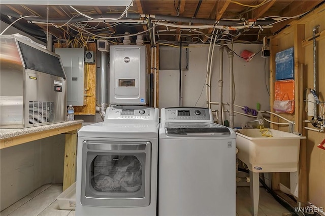 laundry area featuring electric panel, laundry area, a sink, and separate washer and dryer