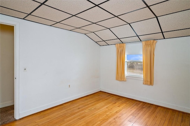 additional living space featuring baseboards and light wood-style floors