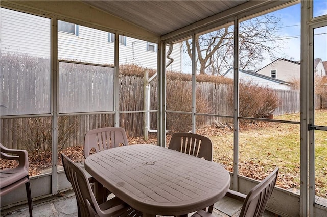 sunroom / solarium featuring vaulted ceiling