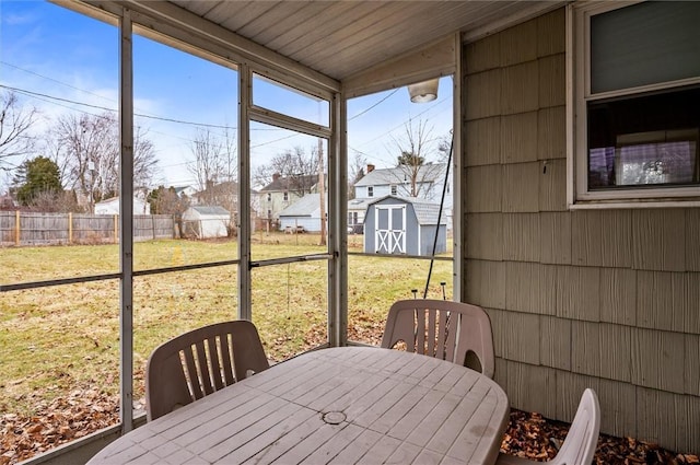 sunroom with a residential view and vaulted ceiling