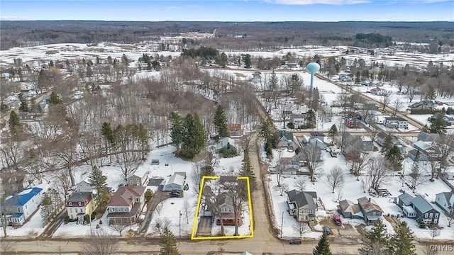 snowy aerial view with a residential view