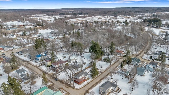 snowy aerial view with a residential view