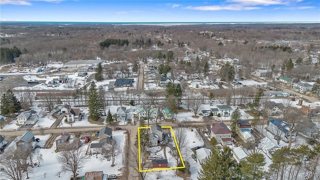 snowy aerial view with a residential view