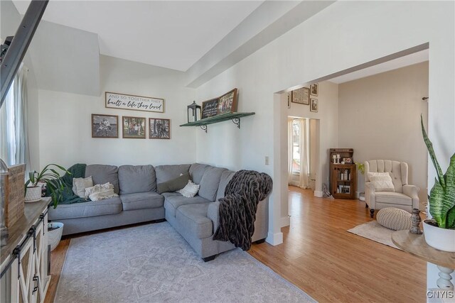 living area with light wood-style flooring and baseboards