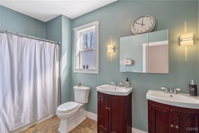 full bathroom with toilet, two vanities, a shower with curtain, and a sink