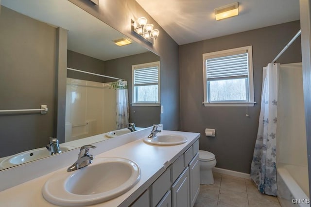 bathroom with tile patterned floors, toilet, and a sink