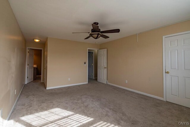 unfurnished bedroom with carpet flooring, ceiling fan, and baseboards