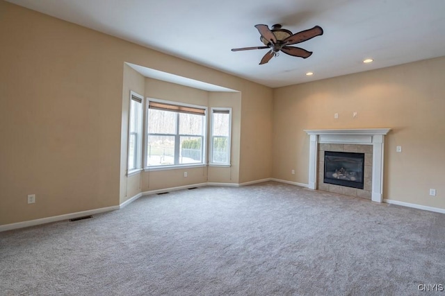 unfurnished living room featuring recessed lighting, a fireplace, baseboards, and carpet floors