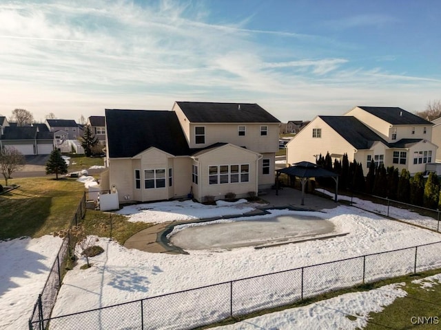 back of property with a gazebo, a residential view, and a fenced backyard