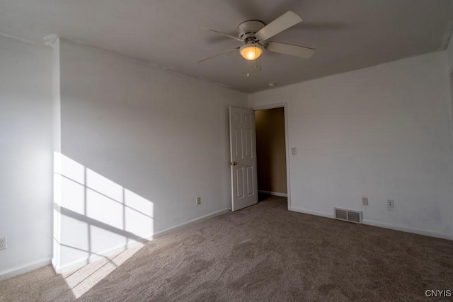 unfurnished room featuring visible vents, baseboards, carpet, and ceiling fan