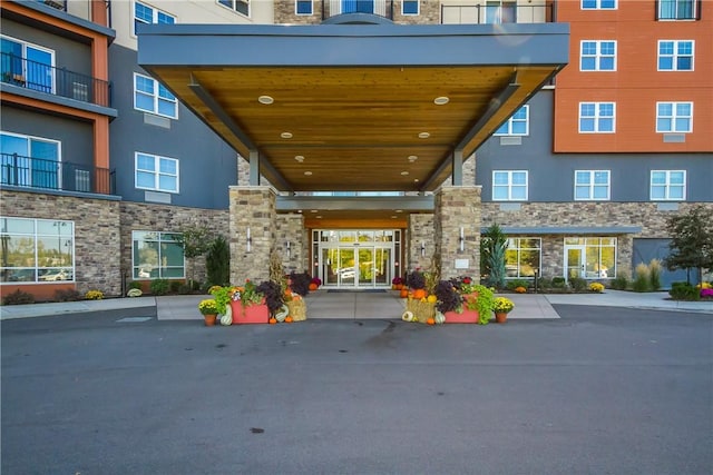 entrance to property featuring stone siding